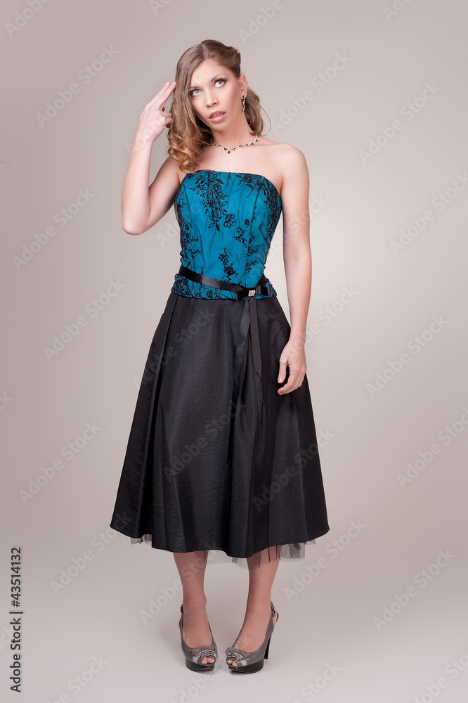 Fototapeta premium Beautiful young woman wearing a sexy dark evening dress