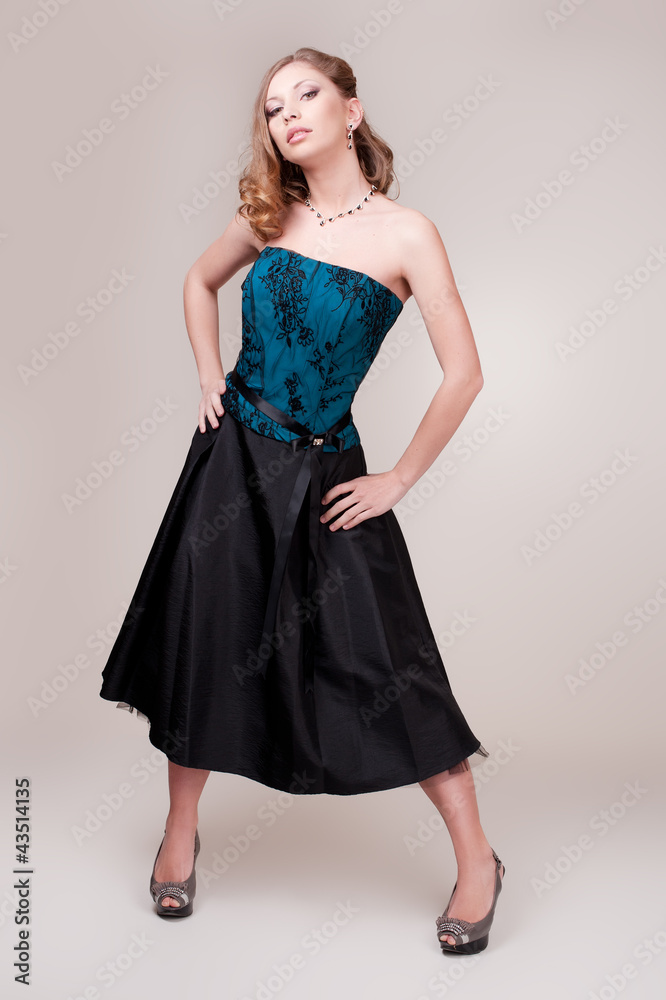 Beautiful young woman wearing a sexy dark evening dress Beautiful young woman wearing a sexy dark evening dress