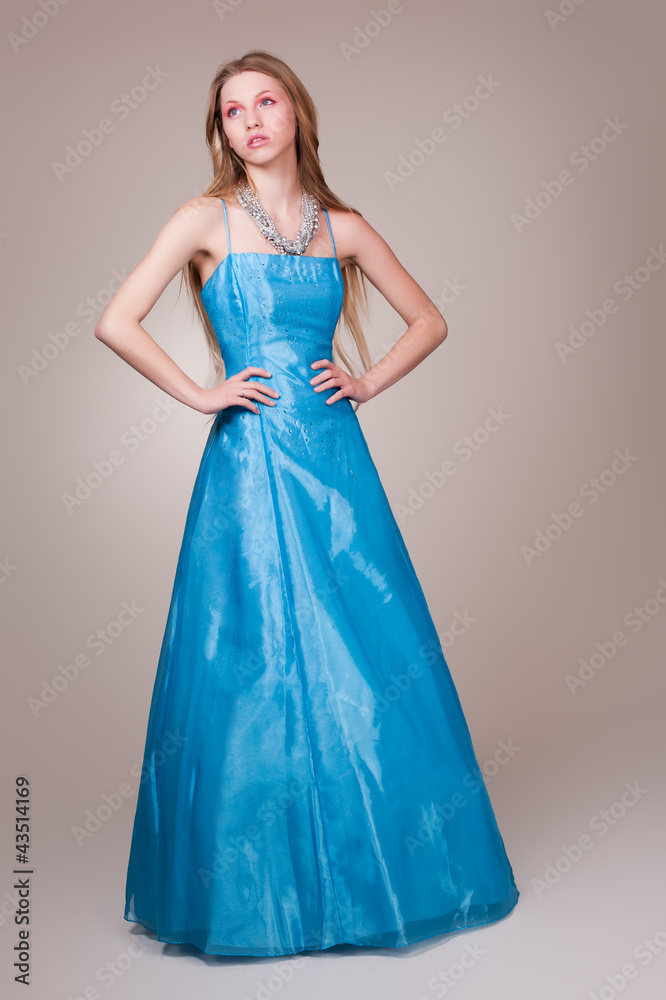 Beautiful young woman wearing a sexy blue evening dress Beautiful young woman wearing a sexy blue evening dress