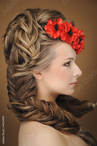 Beautiful woman in bright red poppy wreath, closeup