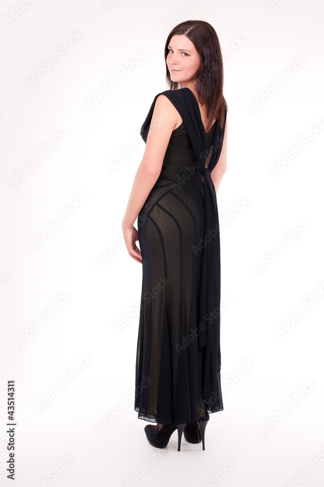 Beautiful young woman wearing a sexy black evening dress