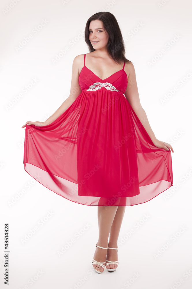 Beautiful young woman wearing a sexy red evening dress