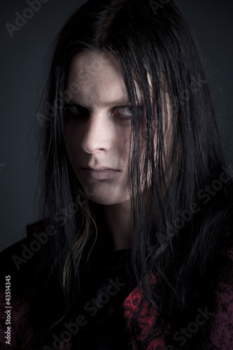 studio portrait of a man dressed as a vampire