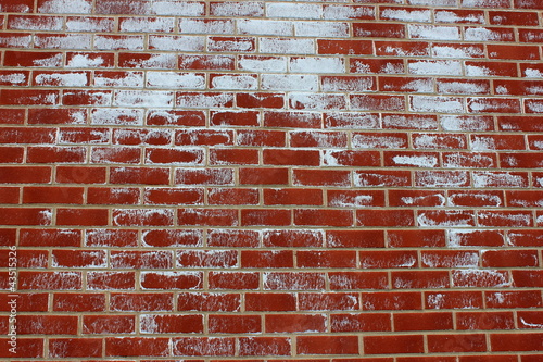 Old red brick wall with white paint splatter