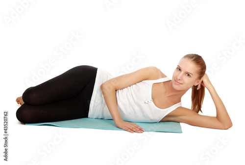 A sportive young woman lying on the floor