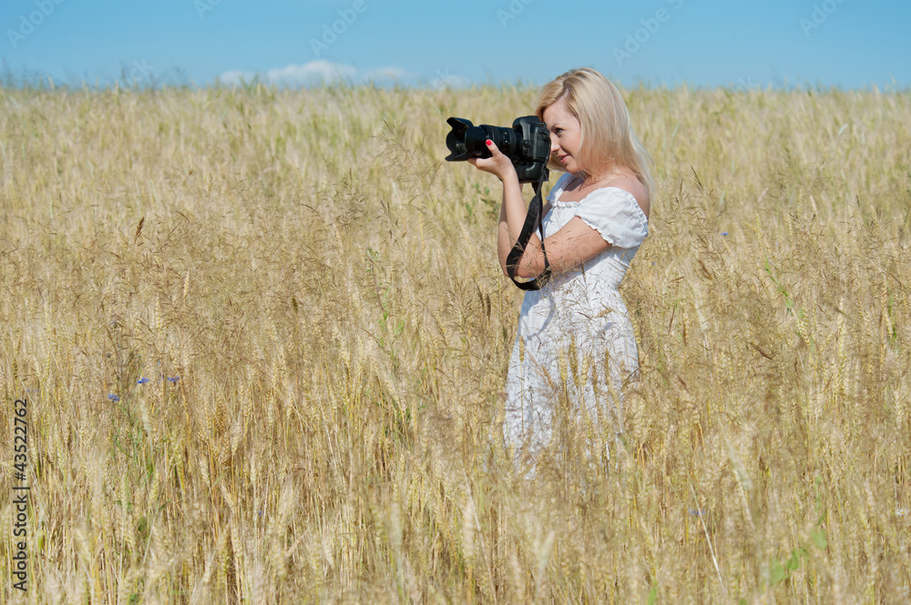 Beautiful woman take a photo with camera in a field Beautiful woman take a photo with camera in a field