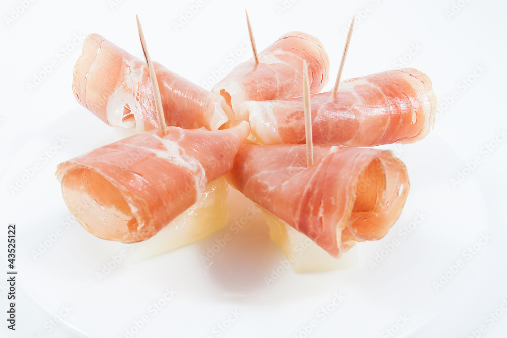 Jamon ham with melon plate isolated on white Jamon ham with melon plate isolated on white