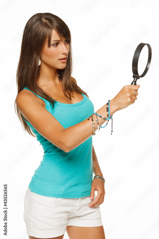 Young female looking through the magnifying glass Young female looking through the magnifying glass