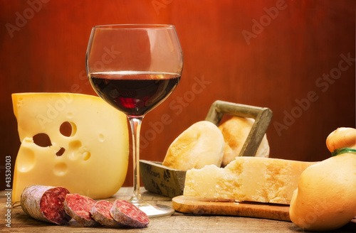 selection of dairy product, salami and red wine