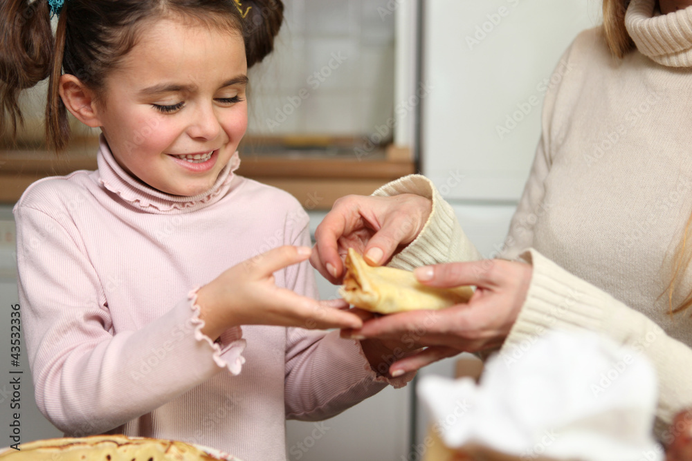 Woman and child making pancakes Woman and child making pancakes