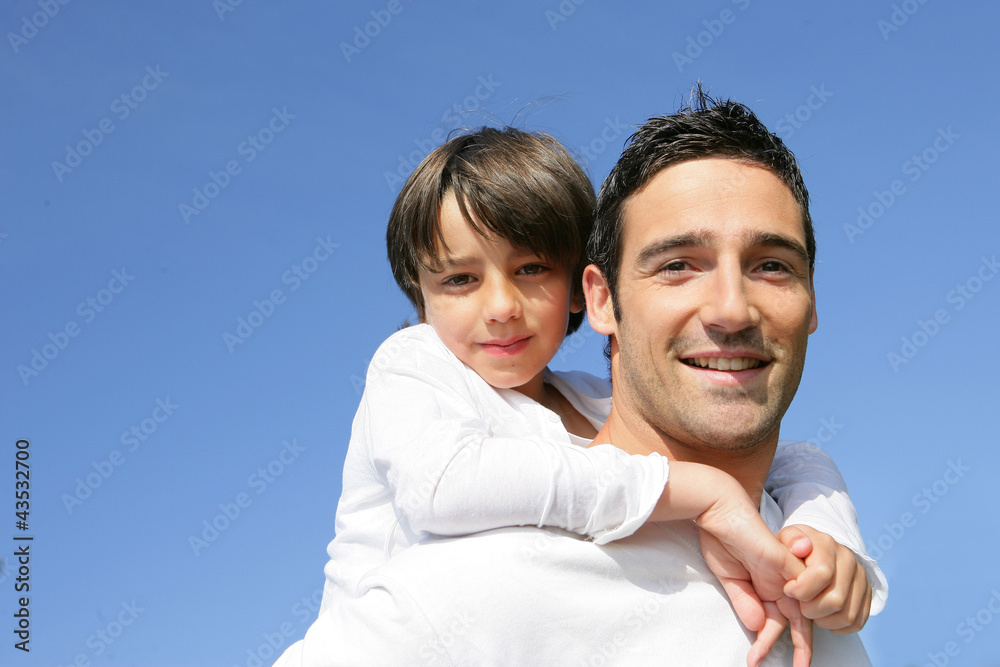 little boy on his father's back little boy on his father's back