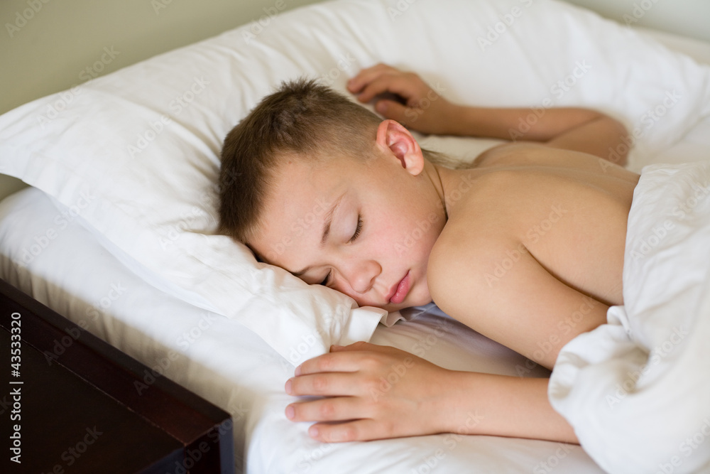 Sleeping boy in bed. Morning. Boy is nine years old. Sleeping boy in bed. Morning. Boy is nine years old.