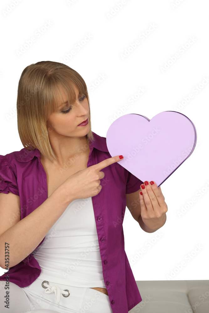 Woman pointing to a heart-shaped box