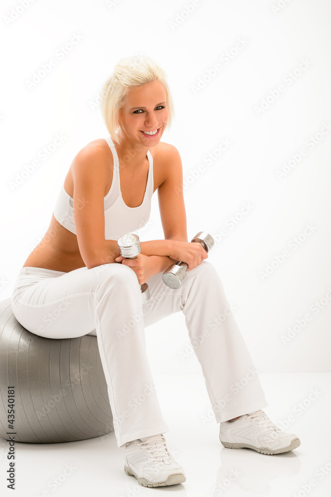 Woman with dumbbells relax on fitness ball Woman with dumbbells relax on fitness ball