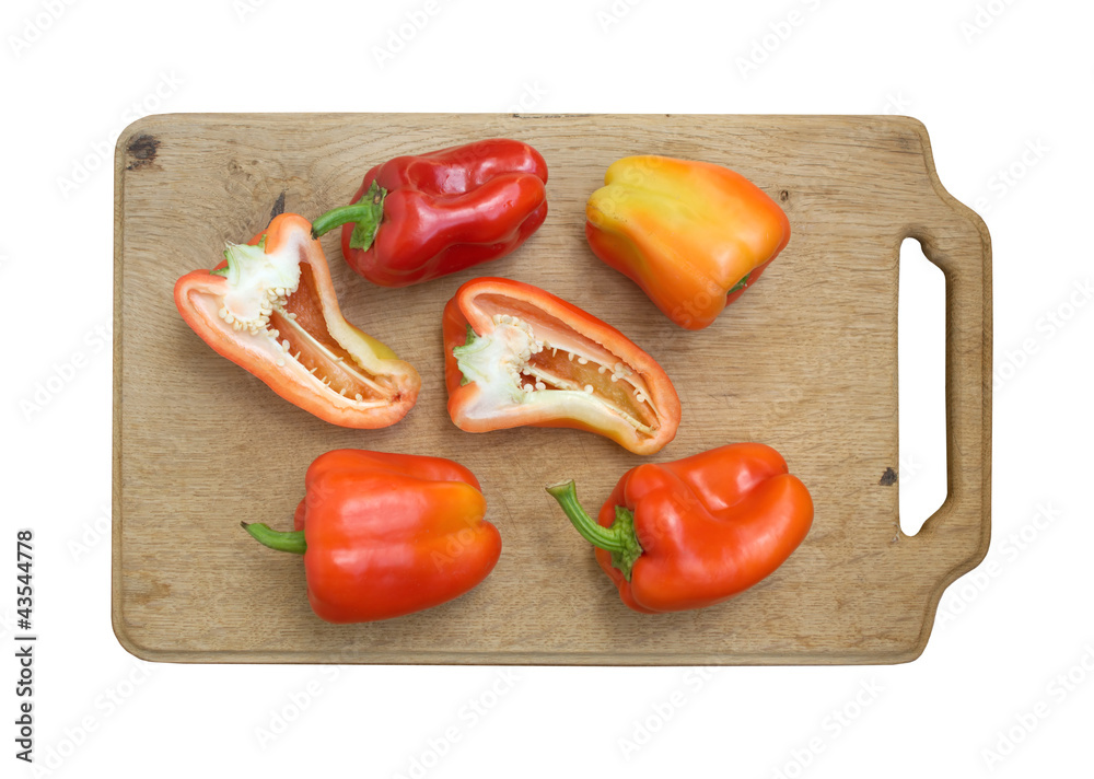 Sweet peppers on kitchen cutting board isolated Sweet peppers on kitchen cutting board isolated