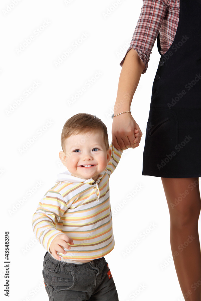The little boy holds the mommy by the hand The little boy holds the mommy by the hand