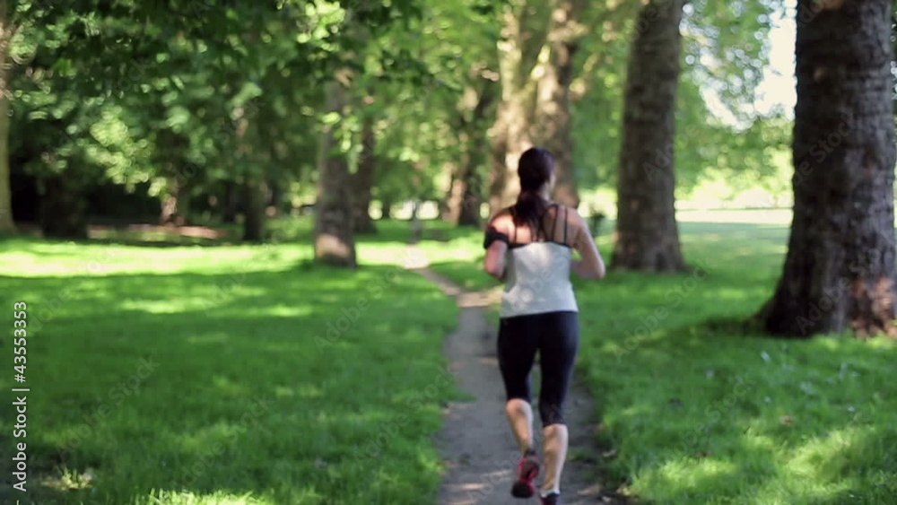 Woman jogging in the park, slow motion Woman jogging in the park, slow motion