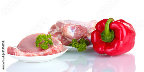 Fresh pepper with raw chicken drumsticks and pork steak