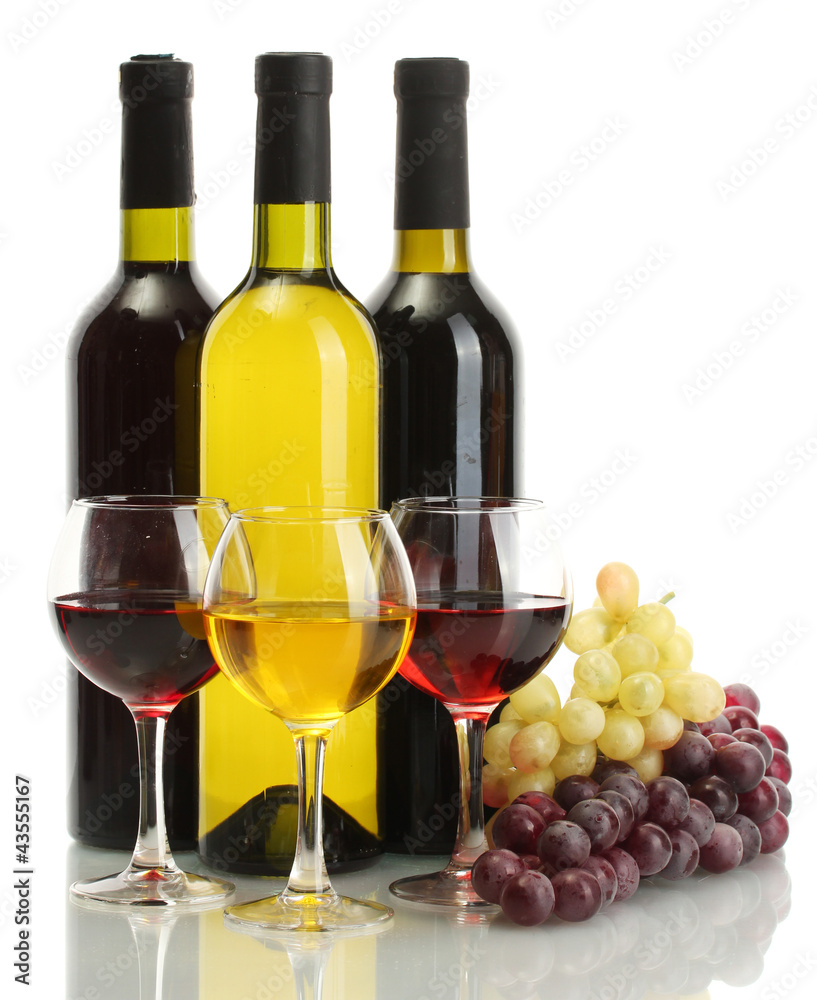 Fototapeta premium Red and white wine bottles with full glasses and fresh grapes, isolated on a clean white background, this arrangement represents a classic still life composition for wine and beverage concepts