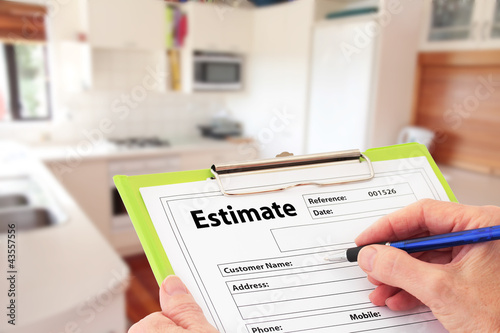 Hand Writing an Estimate for Kitchen Renovation