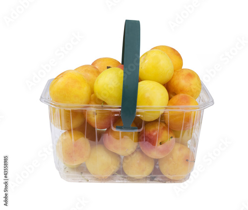 basket full of fresh yellow plums  isolated