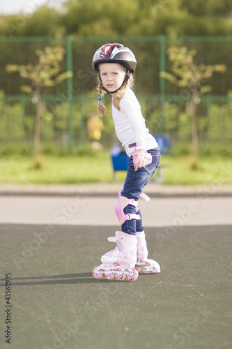 portrait of angry blond caucasian girl skating on a track