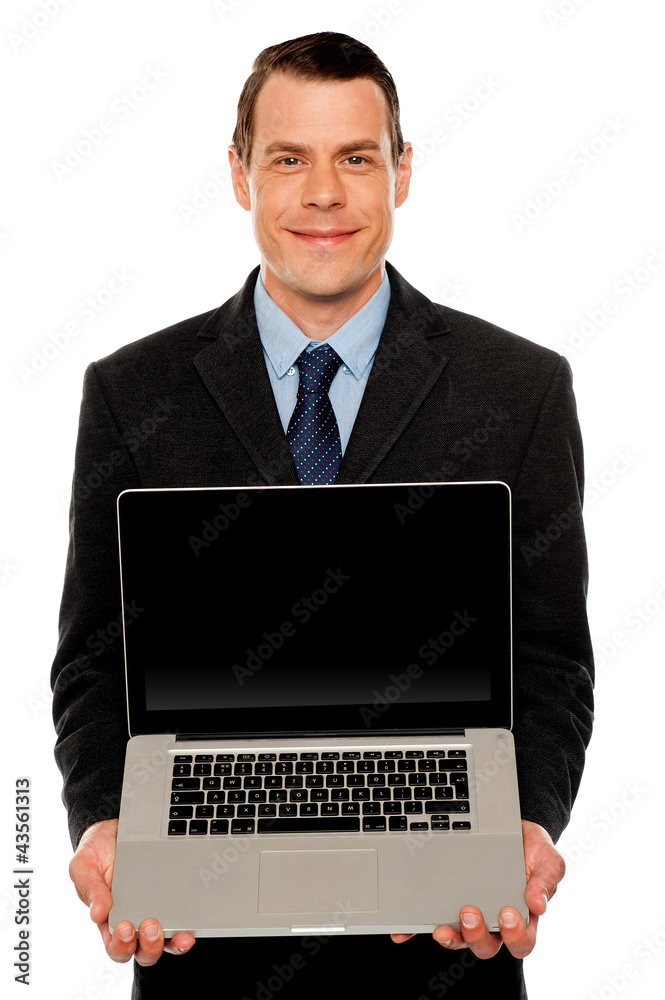 Smart businessman displaying laptop to you Smart businessman displaying laptop to you