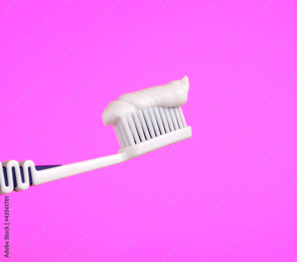 Toothbrush with Toothpaste on Pink Background Toothbrush with Toothpaste on Pink Background