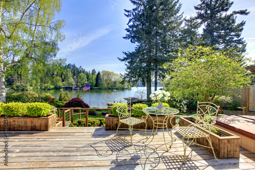 Large deck with chairs and water lake view..