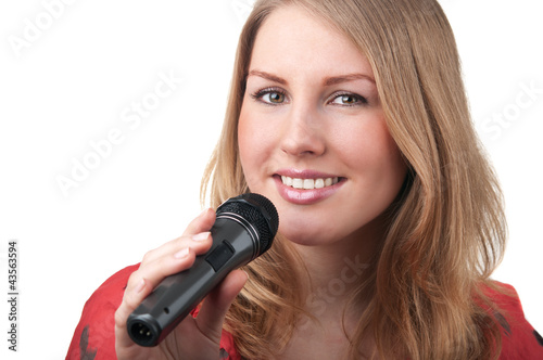 Woman singing into a microphone