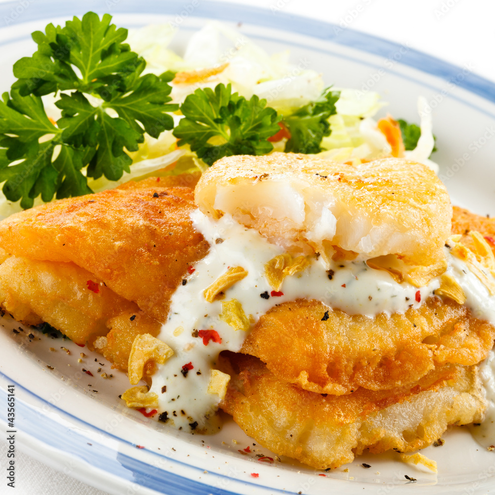 Fish dish - fried fish fillets and vegetable salad Fish dish - fried fish fillets and vegetable salad