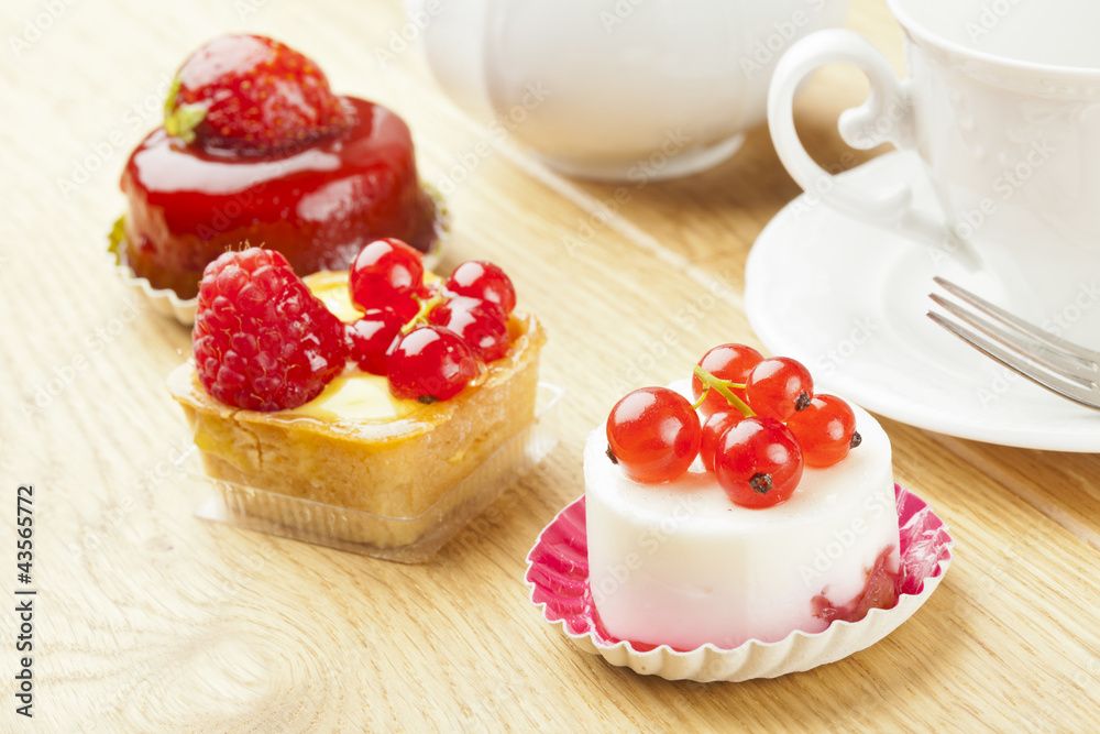 fruit pastry little cake with tea cup on  wooden table