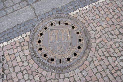 Sewer manhole with ñoat of arms of Prague