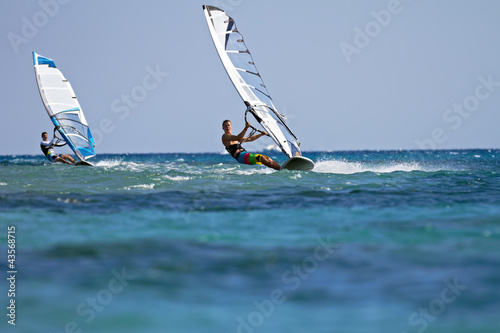 Two windsurfers in action