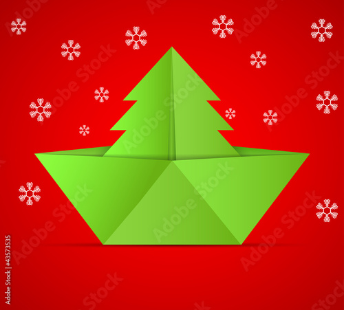 concept of the Christmas tree and origami boat.