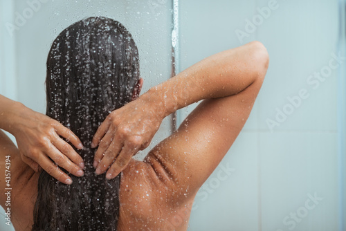 Portrait of relaxed woman taking shower photo