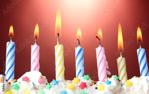 beautiful birthday candles on red background