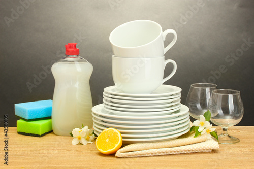 empty clean plates, glasses and cups with dishwashing liquid,