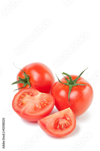 Vertical shot of ripe tomatoes isolated on white