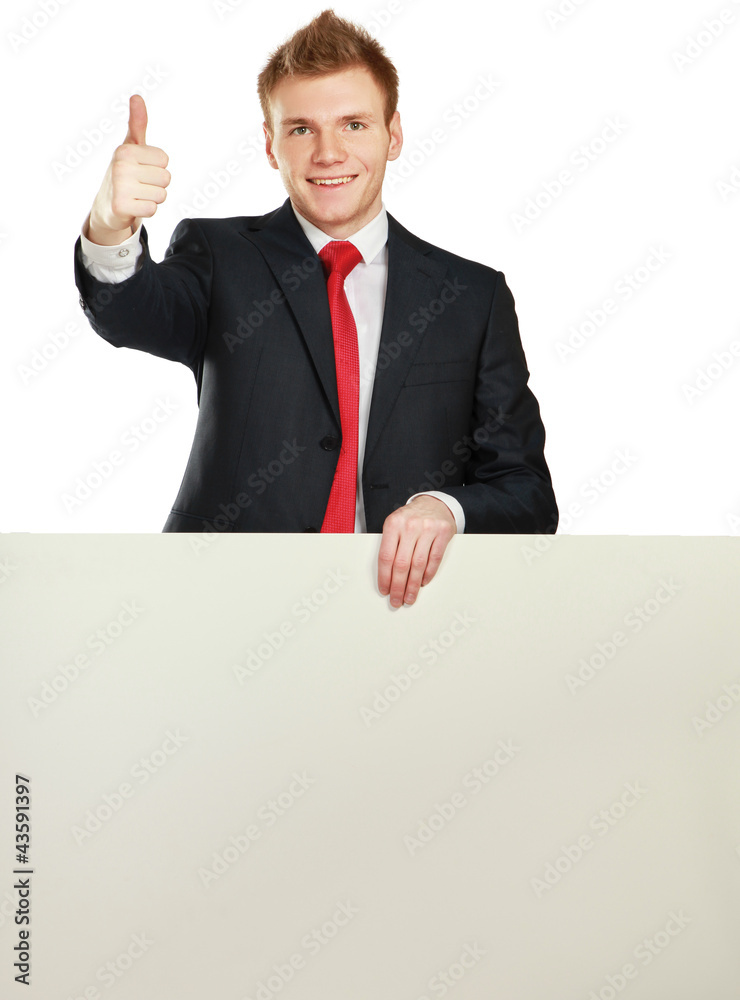 Young businessman with blank board showing thumb up Young businessman with blank board showing thumb up