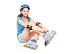 A girl putting on roller skates