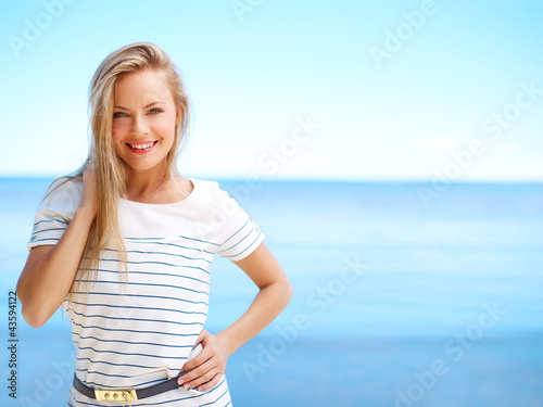 Young attractive woman near the ocean on a summer day