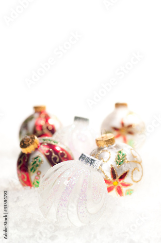 Glass Christmas baubles on snow