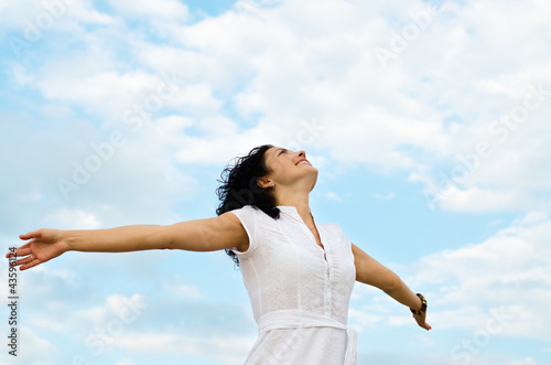Happy woman with outspread arms