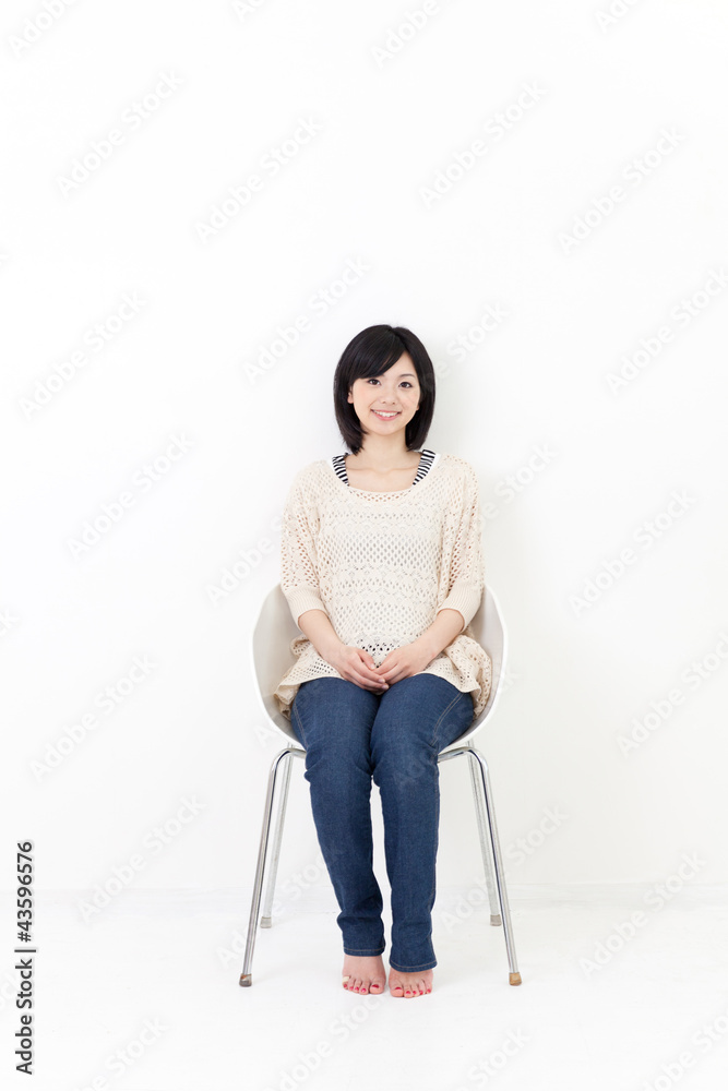 a young asian woman sitting on the chair