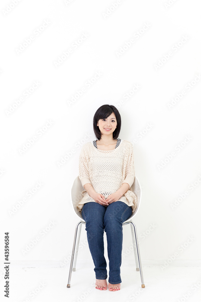 a young asian woman sitting on the chair