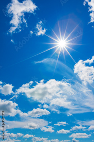 White clouds with sun in the blue sky