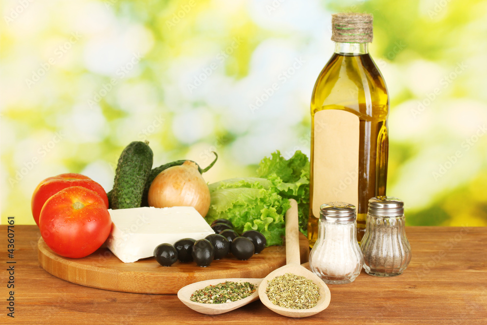 Naklejka Ingredients for a Greek salad on green background close-up