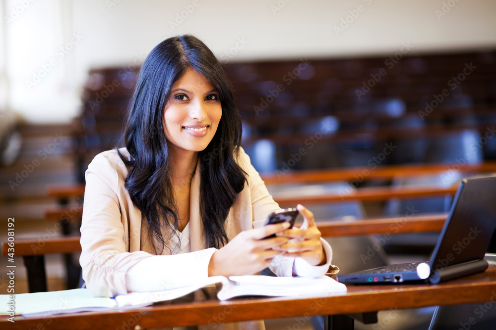 beautiful college student in lecture hall with mobile phone beautiful college student in lecture hall with mobile phone