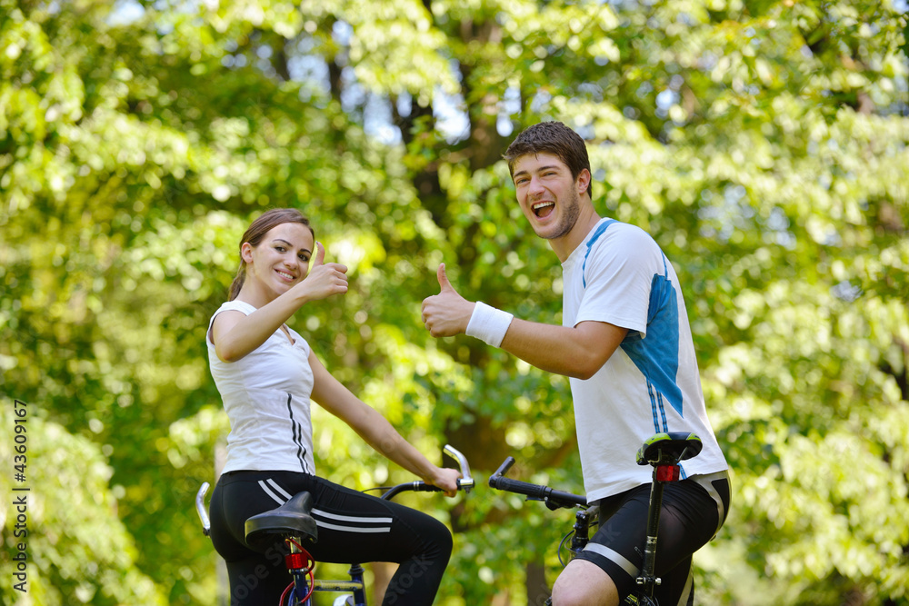 Fototapeta premium Happy couple riding bicycle outdoors